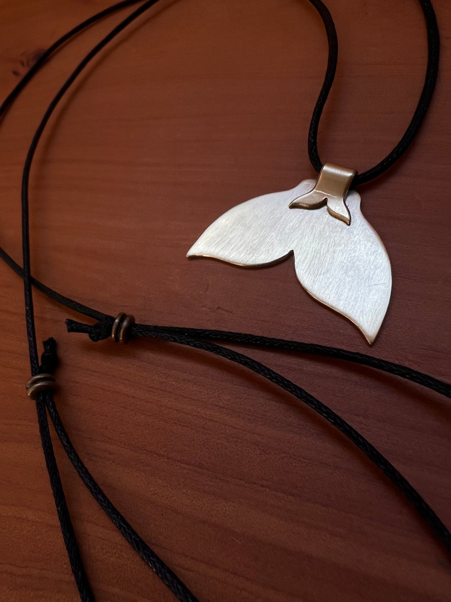 The golden whale tail pendants