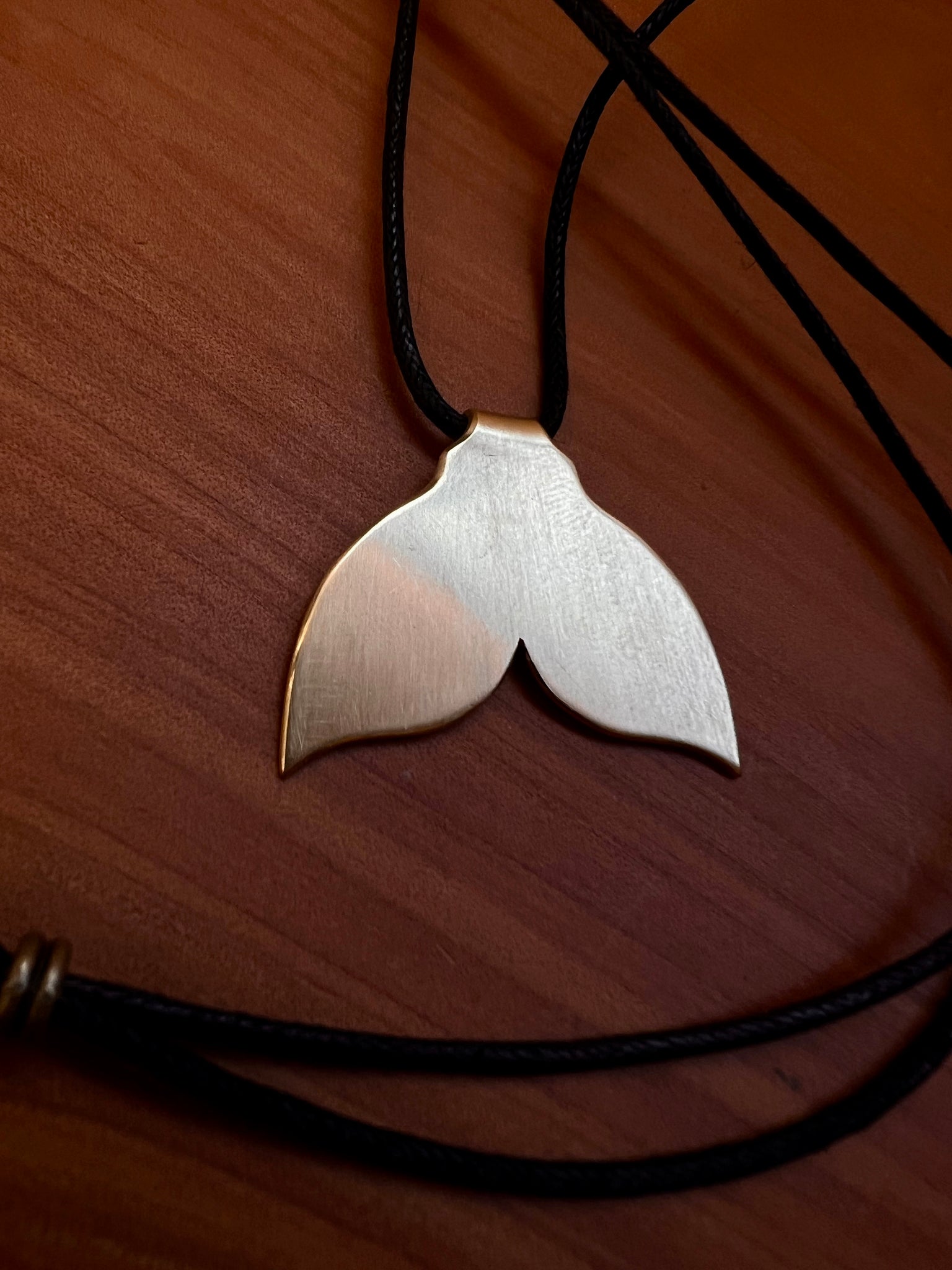 The golden whale tail pendants