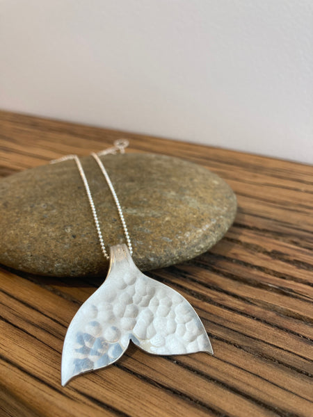 Whale tail pendant hand-sawed made from a vintage silver spoon
